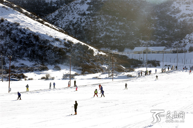 在白云国际滑雪场内，滑雪爱好者们正在初级道上感受冰雪带来的乐趣。